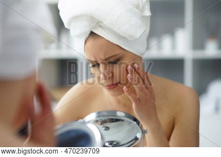 Young Woman Sits In The Bathroom In Front Of The Makeup Mirror And Does Cosmetic Procedures. Beautif
