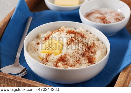Rice Pudding With Butter Cinnamon. French Riz Au Lait, Norwegian Risgrot, Traditional Breakfast Dess