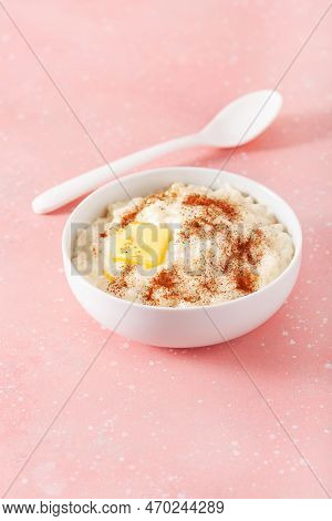 Rice Pudding With Butter Cinnamon. French Riz Au Lait, Norwegian Risgrot, Traditional Breakfast Dess