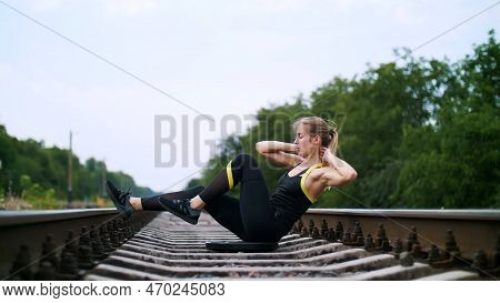 Beautiful Sexy Athletic Young Blond Woman In Black Leggings Performing Exercises To Make Strong Pres
