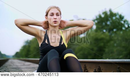 Beautiful Sexy Athletic Young Blond Woman In Black Leggings Performing Exercises To Make Strong Pres