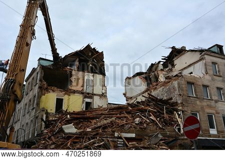 The Ruins Of An Earthquake-damaged Residential Building With Broken Walls, Brick Fragments And Roof 