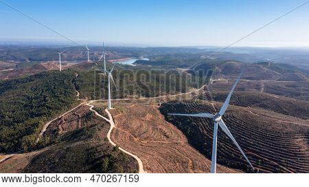 Wind Turbines Generate Clean, Green Electricity In The Fields Of Portugal. With A View Of The Bravur
