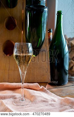 Glass Of Sparkling White Wine Champagne Or Cava With Bubbles And Classic Wooden Champagne Pupitre Ra