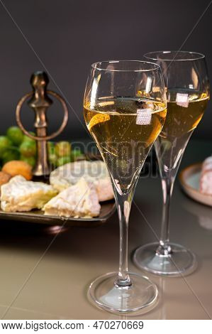 Glasses Of Sparkling White Wine Champagne Or Cava With Bubbles And French Soft Cheese On Background