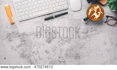 Modern Office Desk Workplace With Keyboar Computer, Pen, Mouse, Eyeglass, Notebook And Cup Of Coffee