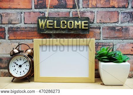Empty Photo Frame Mock Up With Welcome Sign And Artficial Plant Home Decoration