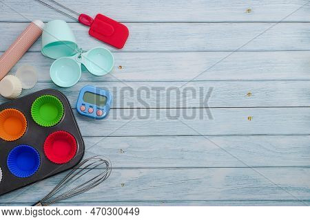Top View Set Of Kitchen Utensils And Ingredients For Bakery On Blue Wooden Floor. Materials Or Kitch