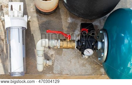 The System Of Modern Water Supply In A Country House From A Well Source. Hydraulic Accumulator For F
