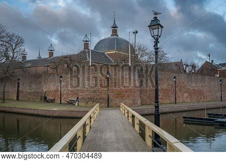 Dutch City Of Leerdam At Dusk, View Of The Harbor And The Historical City Wall