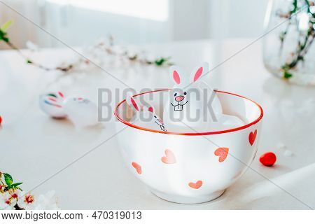 Close Up Funny Easter Eggs Containers With Bunny Ears Filled With Candy And Chocolate In A Bowl On T