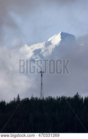 Communication Tower And Tantalus Range Covered In Snow During Winter Season. Near Whistler And Squam