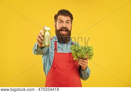 Happy Man Giving Juice Bottle Holding Fresh Lettuce Yellow Background, Juice Barkeeper