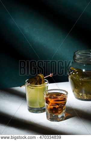 Pickleback, Alcoholic Cocktail Made From Cucumber Pickle And Whiskey In Small Shot Glasses. Hard Lig