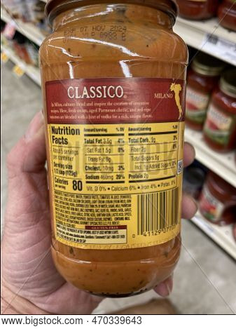 Grovetown, Ga Usa - 01 13 23: Grocery Store Hand Holding Classico Spaghetti Sauce Ingredients Label