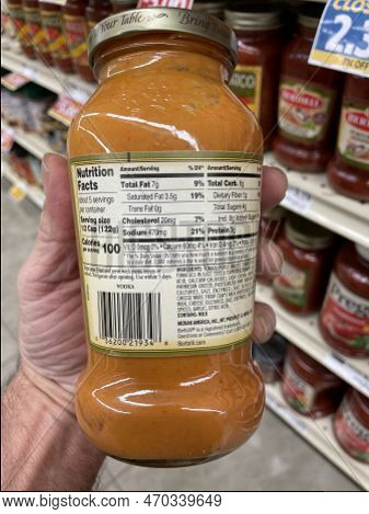 Grovetown, Ga Usa - 01 13 23: Grocery Store Hand Holding Bertolli Spaghetti Sauce Ingredients Label