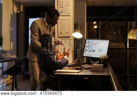 Advisor Agent Showing Financial Statistics To Worker, Discussing Marketing Strategy In Startup Offic
