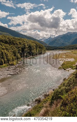 The Makarora River In The Otago Region Of New Zealand Flowing Towards Wanaka Lake With Snow Capped M