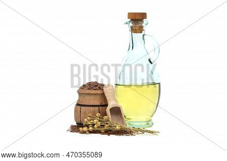 Linseed Oil In Glass Decanter And Flax Seeds In Wooden Scoop And Bunch Of Flax Plants Isolated On Wh