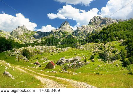 Scenic Landscape Of Mountain Valley In European Alps. Road Goes Into The Distance. Stunning View Of 