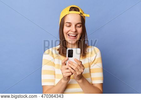 Indoor Shot Of Smiling Happy Cheerful Caucasian Teen Girl Wearing Baseball Cap And Casual T-shirt St