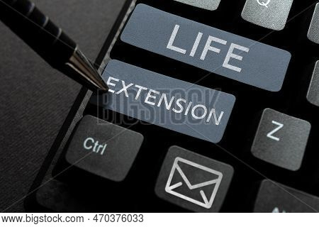 Hand Writing Sign Life Extension. Word For Able To Continue Working For Longer Than Others Of The Sa