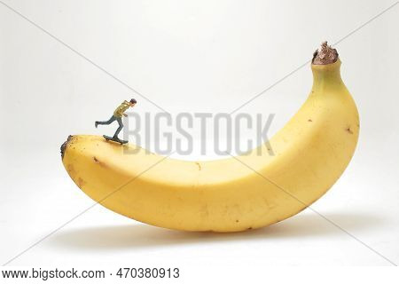 Mini Figure Of Skateboarder Jumping At Banana