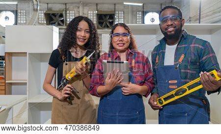 Multi Ethnic Family Working In A Wooden Furniture Factory. Short Black Hair Dad Holding Water Level 