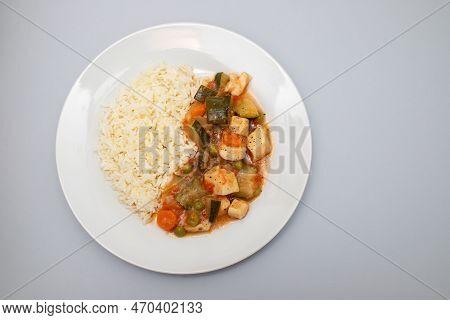 Squid Stew With Vegetables And Boiled Rice On White Plate