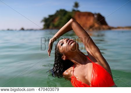Portrait Of Serene Looking Attractive Young Black Female Posing In Bikini In Water. African Model Po