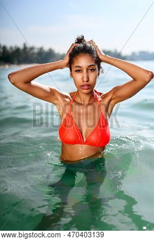 Portrait Of Serene Looking Attractive Young Black Female Posing In Bikini In Water. African Model Po