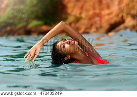 Portrait Of Serene Looking Attractive Young Black Female Posing In Bikini In Water. African Model Po