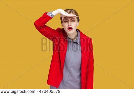 Portrait Of Attentive Concentrated Woman With Red Lips Standing Looking Far, Keeps Hand Near Her For