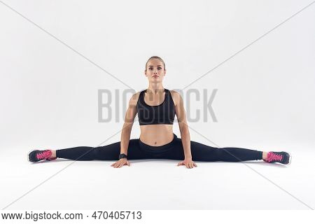 Gymnastic Pose, Stretch. Portrait Of Sporty Blonde Woman Doing Cross-twine Exercising, Stretching He