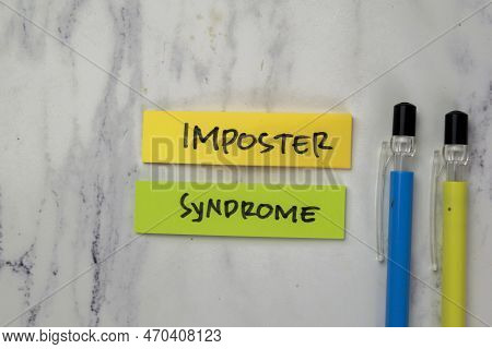 Concept Of Imposter Syndrome Write On Sticky Notes Isolated On Wooden Table.