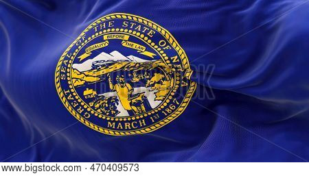Detail Of The Nebraska State Flag Fluttering. The Flag Of Is Blue With The State Seal In The Center.