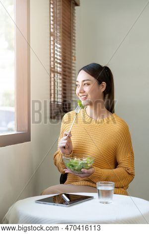 Delighted Woman Eating Food For Health At Home