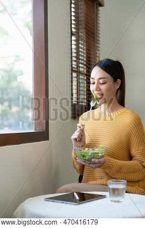 Delighted Woman Eating Food For Health At Home