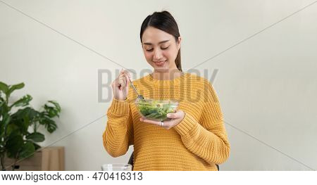 Delighted Woman Eating Food For Health At Home