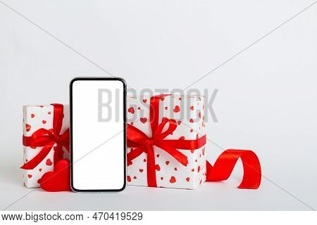 Mobile Phone With Blank Screen On Colored Background With Hearts, Calendar And Gift Box, Valentine D