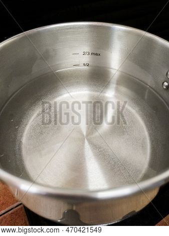 Stainless Steel Pressure Cooker At Work. Liquid Level Markings