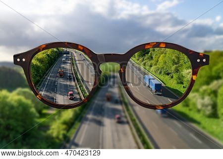 Eye Glasses Against Ametropia Sharp Panorama View Over A Highway Without Of Focus Photo Parts.