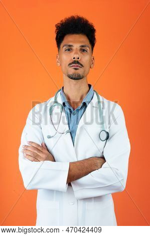 Doctor Or Veterinarian Isolated. Black Young Doctor Medical Resident With Stethoscope On Orange Back