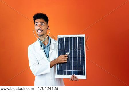 Doctor Or Veterinarian Isolated On Orange Background. Black Young Doctor Medical Resident With Steth