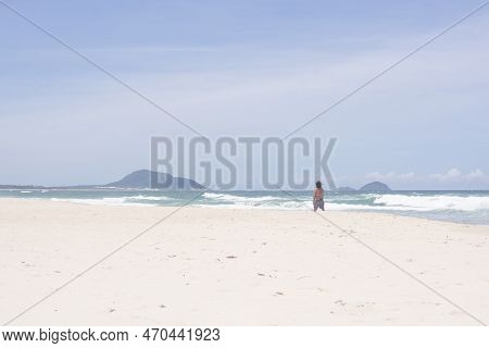 Florianopolis, Brazil - January 22, 2023 : A Man Walks On The Beach Barra Da Lagoa, Florianopolis, B