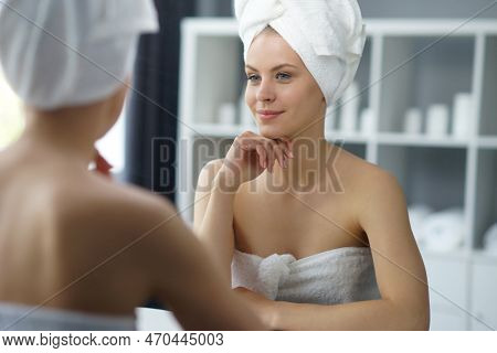 Young Woman Sits In The Bathroom In Front Of The Makeup Mirror And Does Cosmetic Procedures. Beautif