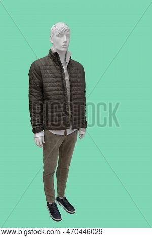 Full Length Image Of A Male Display Mannequin Dressed In Black Quilted Padded Jacket, Sweater And Co