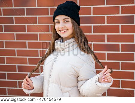 Trendy Teenager Girl On Brick Background. Teenager Girl Outdoor. Teenager Girl Wearing Hat.
