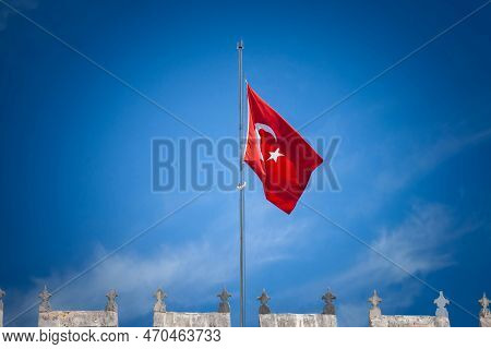 Turkish Flag Floating In The Air In Front Of A Blue Sky In Istanbul. Also Called Turk Bayragi, The F