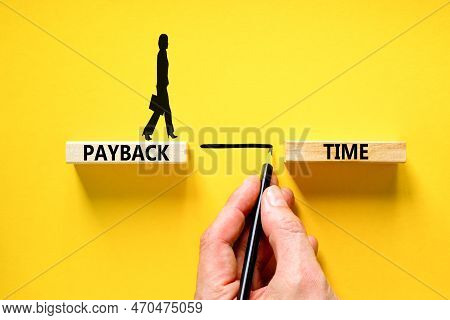 Payback Time Symbol. Concept Words Payback Time On Wooden Blocks. Beautiful Yellow Table Yellow Back